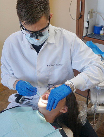 Dr. Beelman cleaning a patient's teeth at his office Beelman Dental in Bedford, TX
