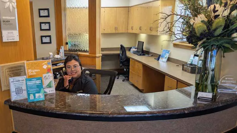 office staff answering patient questions about sedation dentistry over the phone