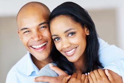 woman smiling with her husband after cosmetic dentistry treatments in Bedford, TX