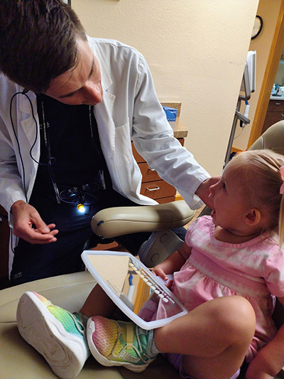 Dr. Beelman during a checkup with a pediatric dental patient at Beelman Dental in Bedford, TX