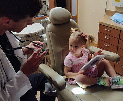 Dr. Beelman providing dental care for a new patient